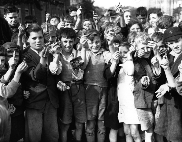 East End kids showing their collected scrap items.