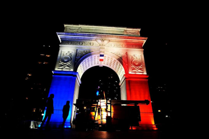 The Washington Square Park arch lit with the French national colours in New York