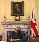 Prime Minister Theresa May signing Brexit letter