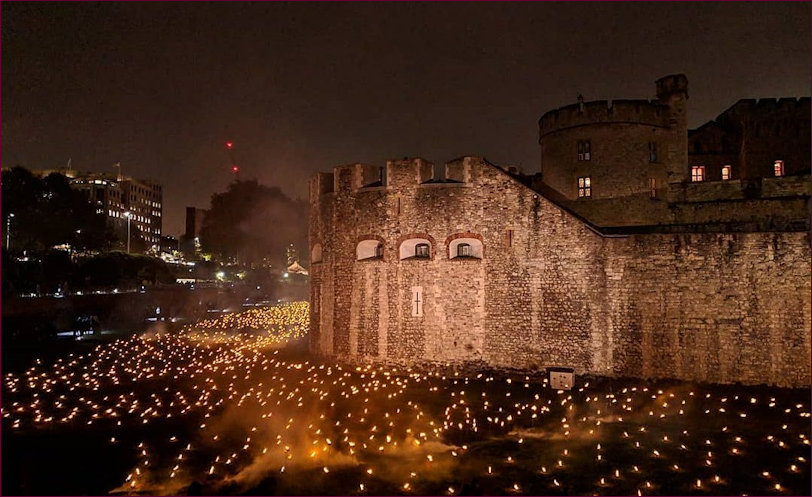 The Tower illuminated and lit up with the torches in the moat