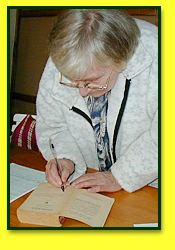 Anne signing documents