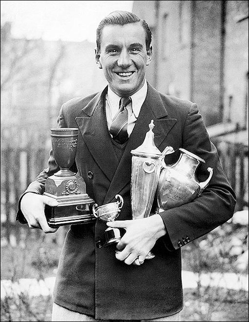 Fred Perry and some of is trophies around 1934