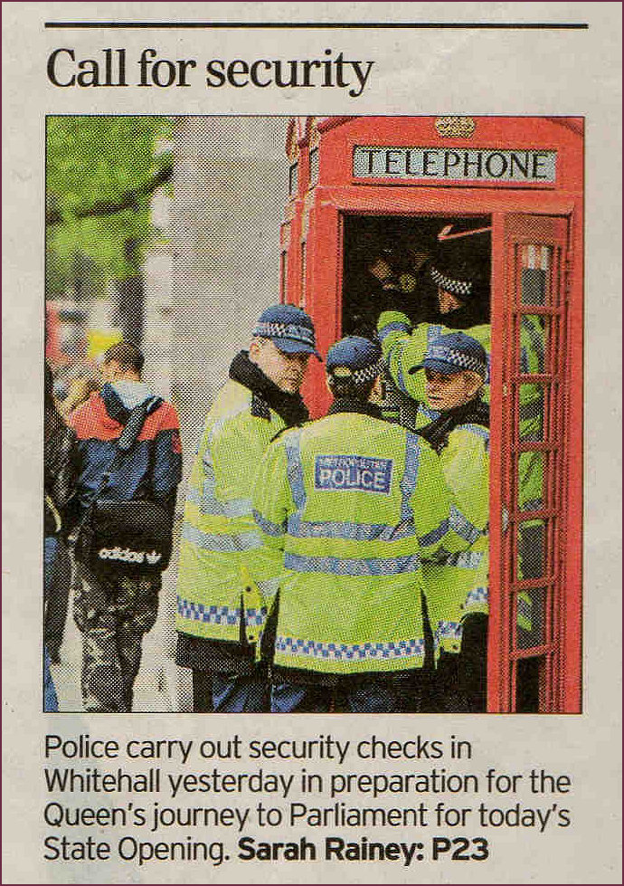 Police Officers checking a telephone kiosk