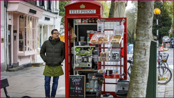 Umar Khalid stands outside the converted red telephone box from where he runs a coffee shop in Hampstead Heath, North London. 