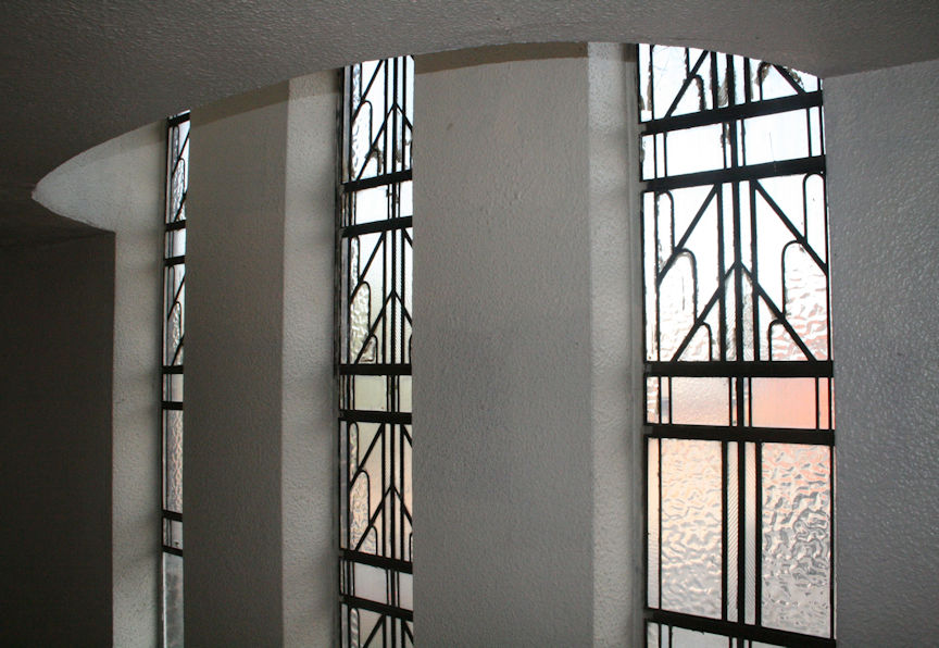 Three windows forming a bay effect on the interior stairwell