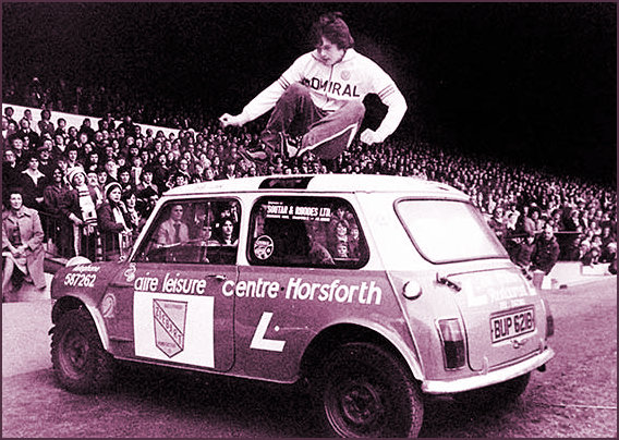 Classic Mini being hurdled by former football star