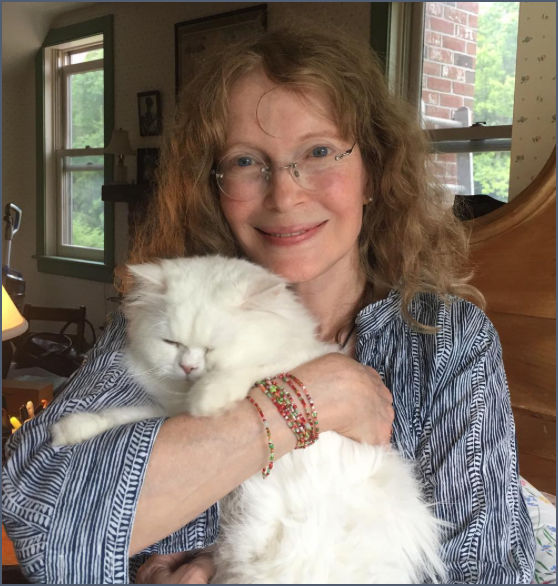 Mia Farrow with white cat in 2016