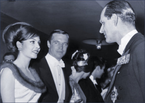 Prince Philip chats to Michele Mercier as George Peppard Looks on admiringly