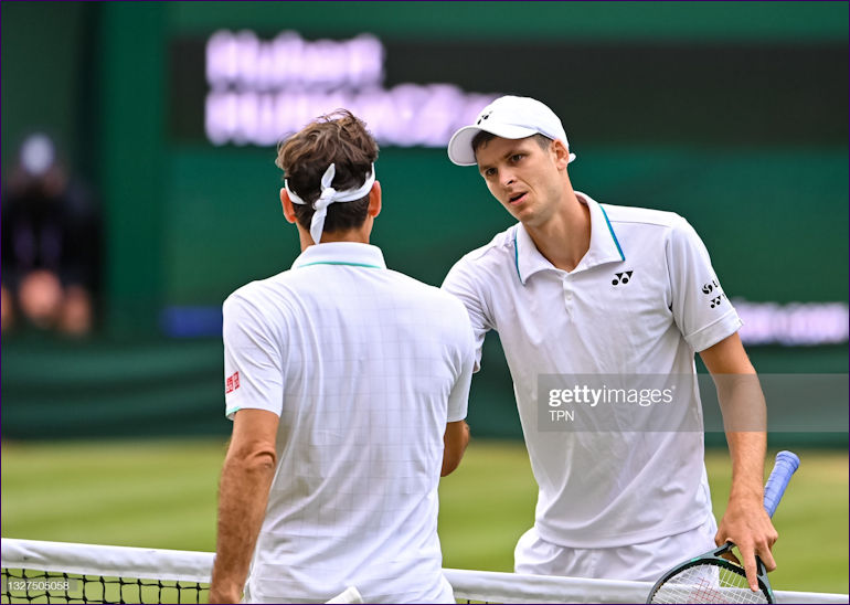 Hurkacz and Federer at the net at Wimbledon 2021